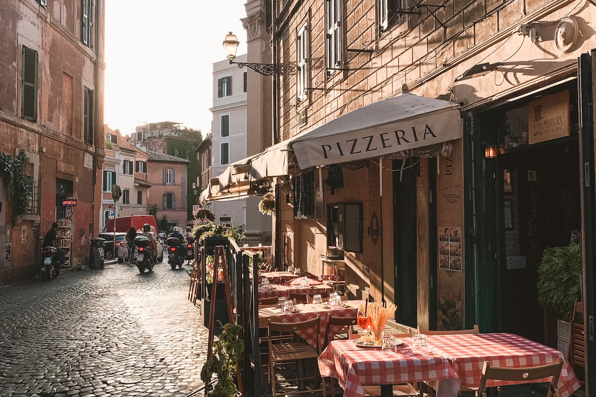 Café tables outside a Roman storefront